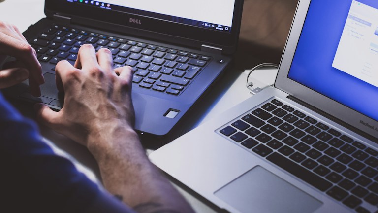 person using black laptop computer