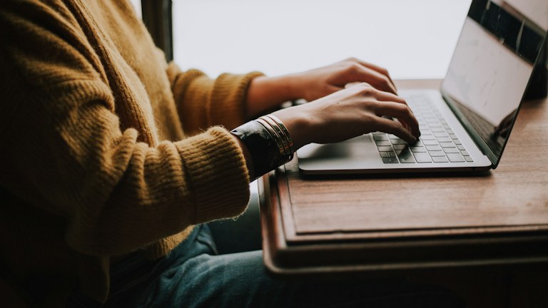 person sitting front of laptop