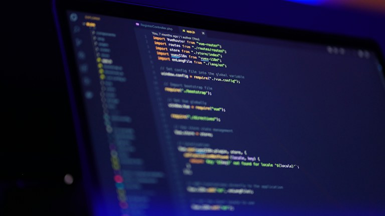 laptop screen displaying colorful code
