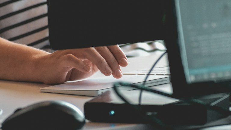 person using computer on table