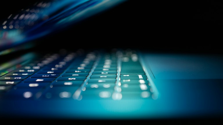 closeup photo of turned-on blue and white laptop computer